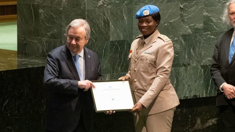 The UN Secretary-General António Guterres (left) presents the 2022 Military Gender Advocate of the Year Award to Captain Cecilia Erzuah from Ghana